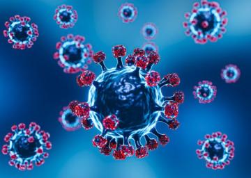 Foto com fundo azul mostrando vírus da covid-19 que são microesferas com lanças fixadas nelas.
