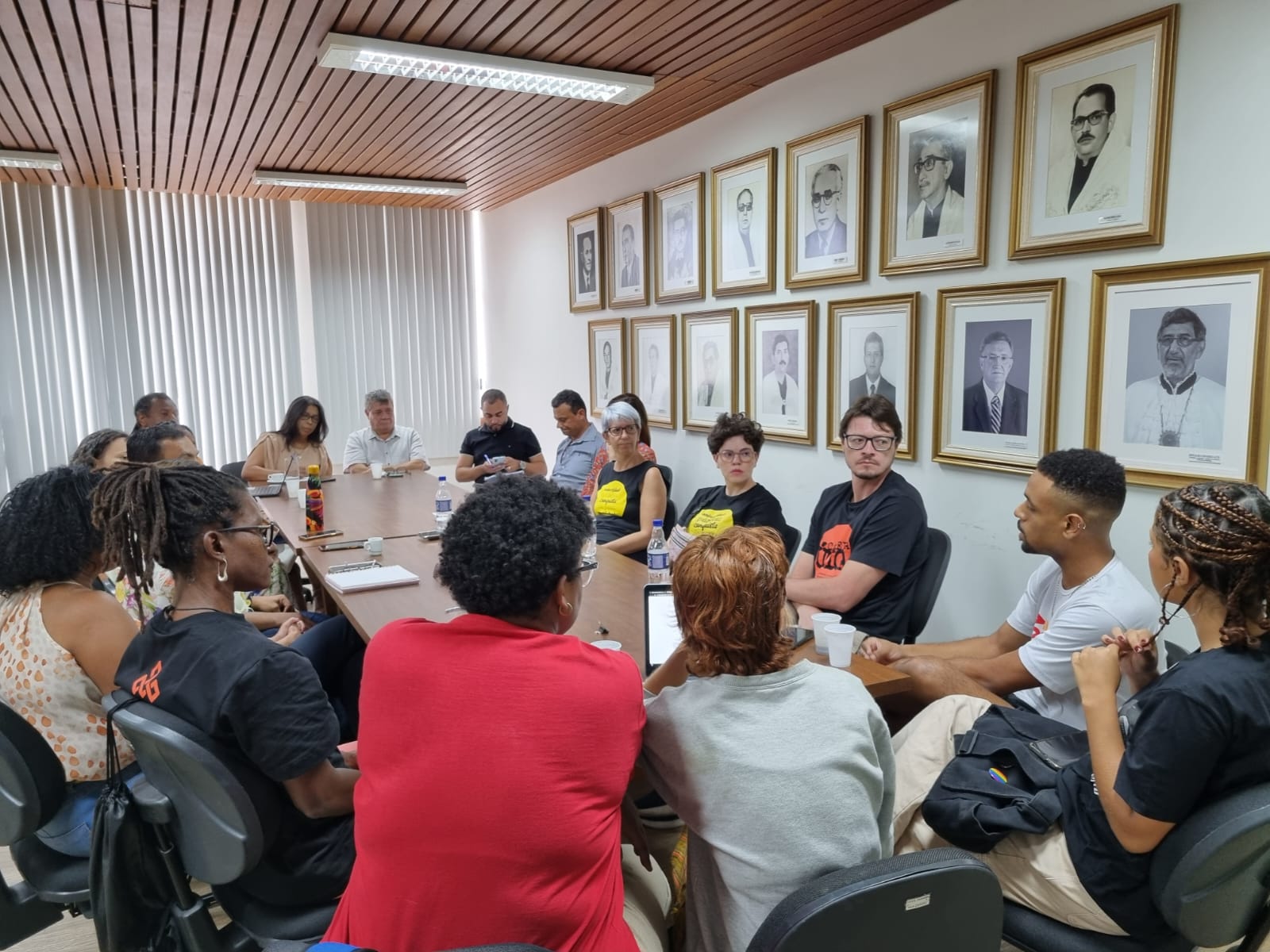 Sala de reuniões da reitoria com gestores da Ufes e representantes da Adufes e do DCE sentados em volta da mesa.
